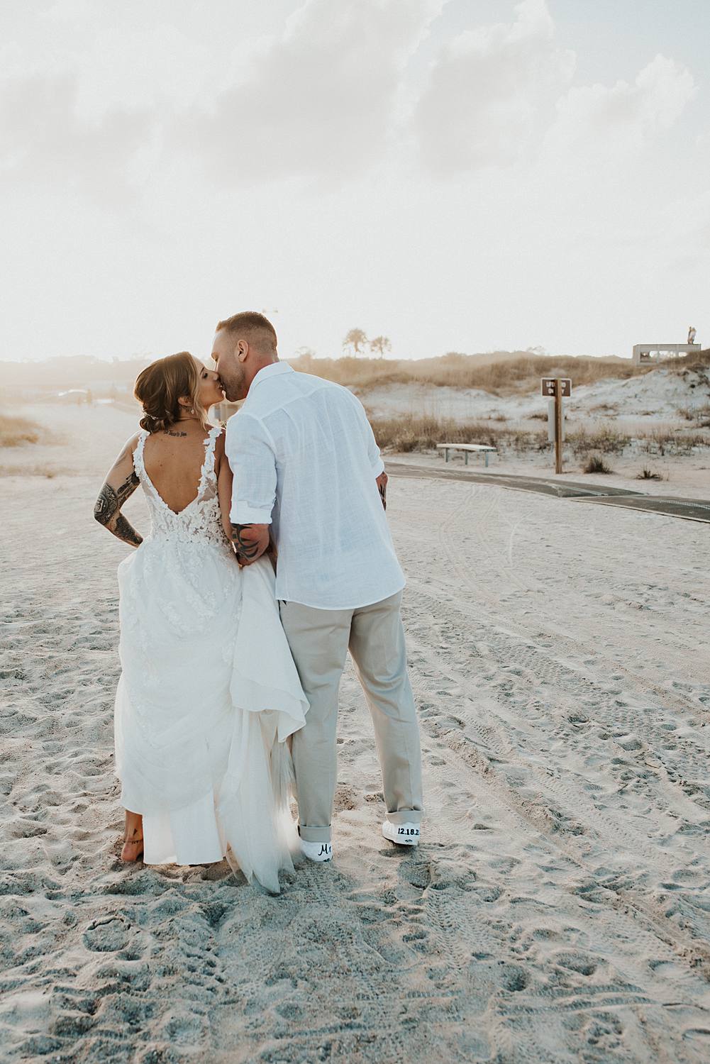 Bride and groom kissing on Saint Anastasia beach