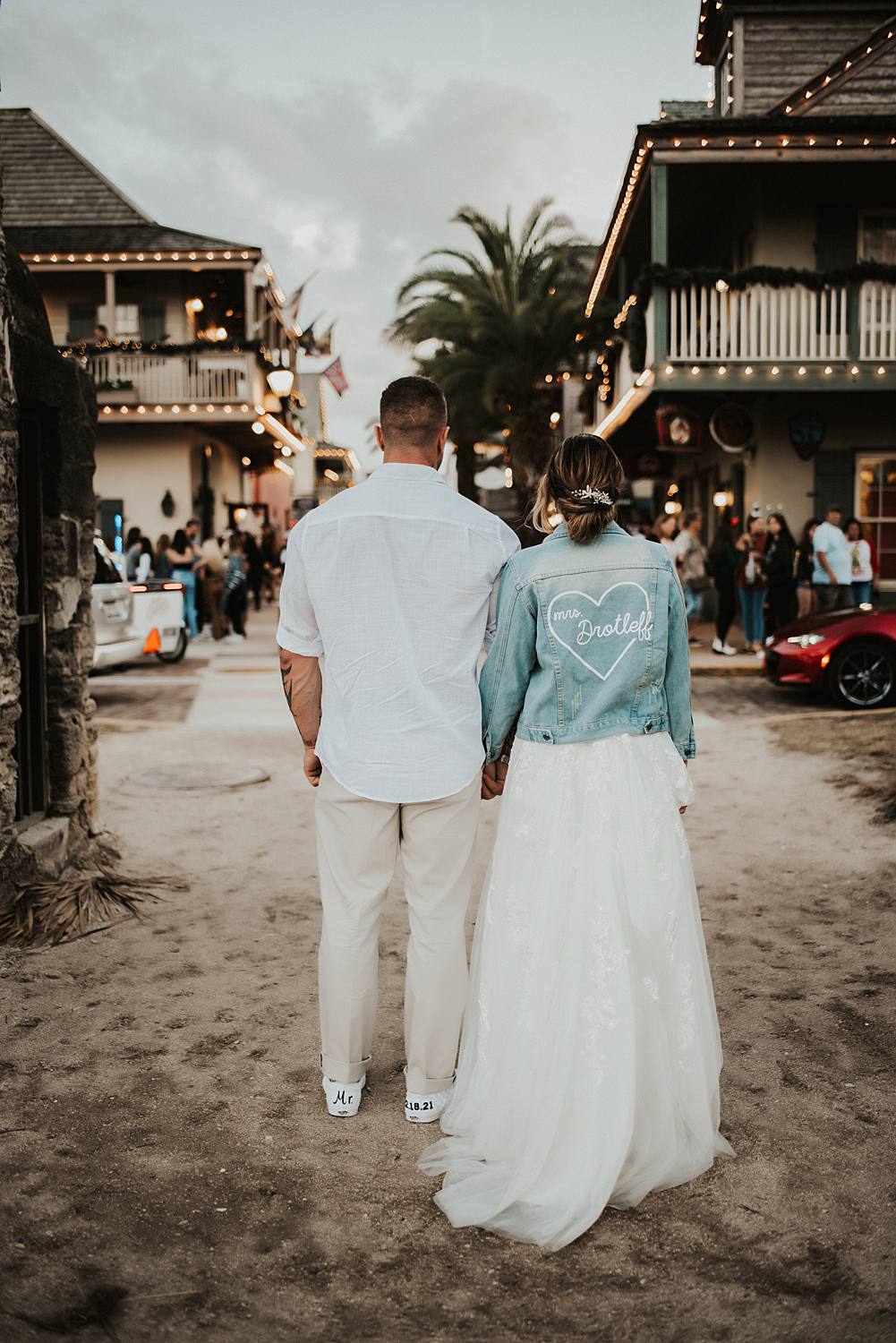 Bride and groom holding hands on Saint George street