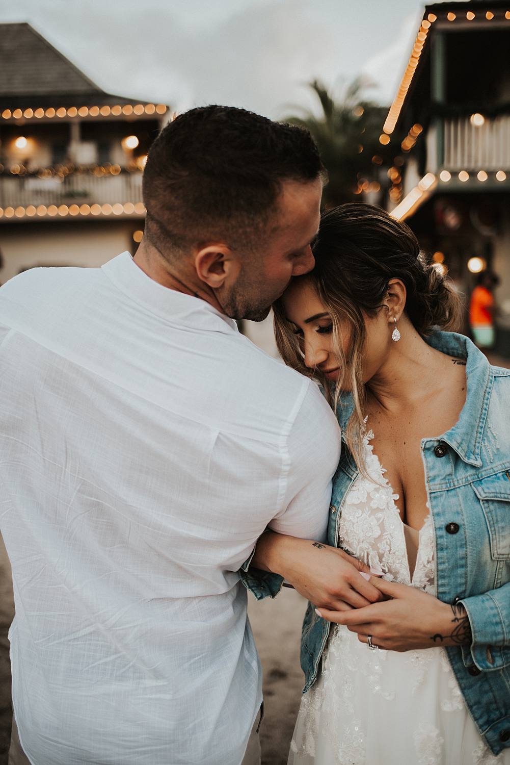 Groom kissing brides forehead