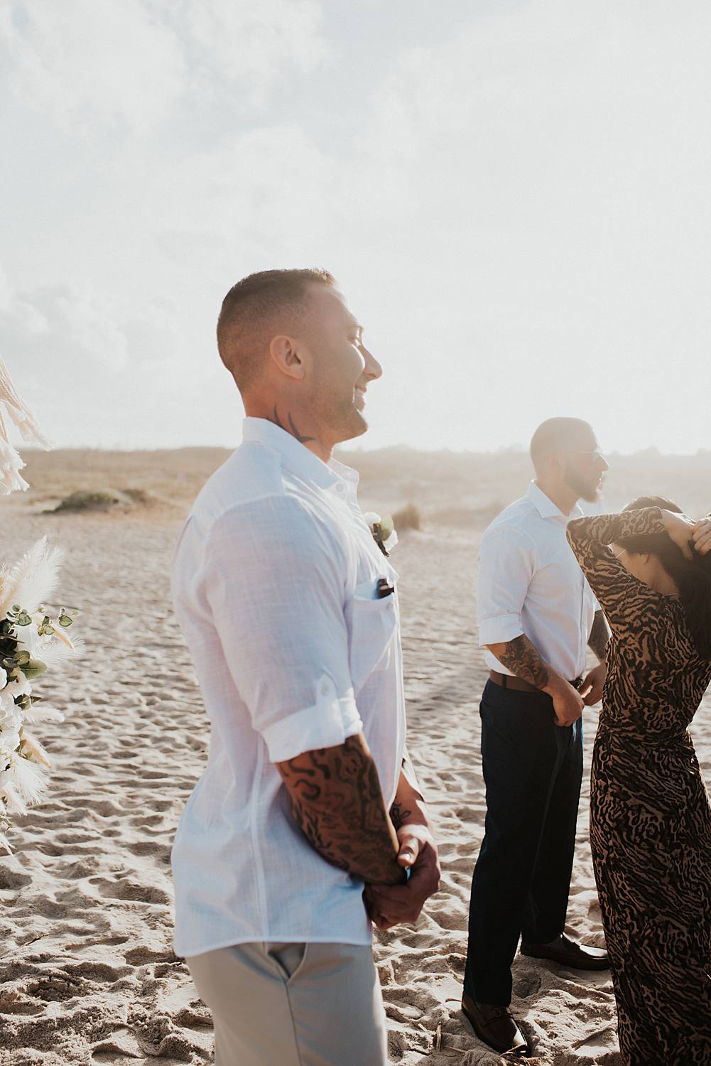 Groom seeing bride walk down the aisle at beach wedding