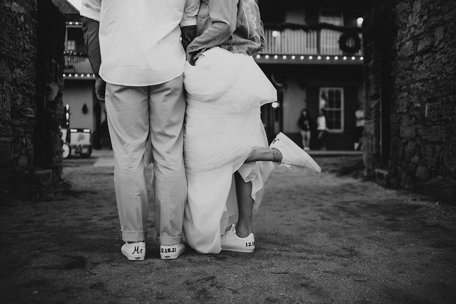 Bride kicking leg back in custom vans