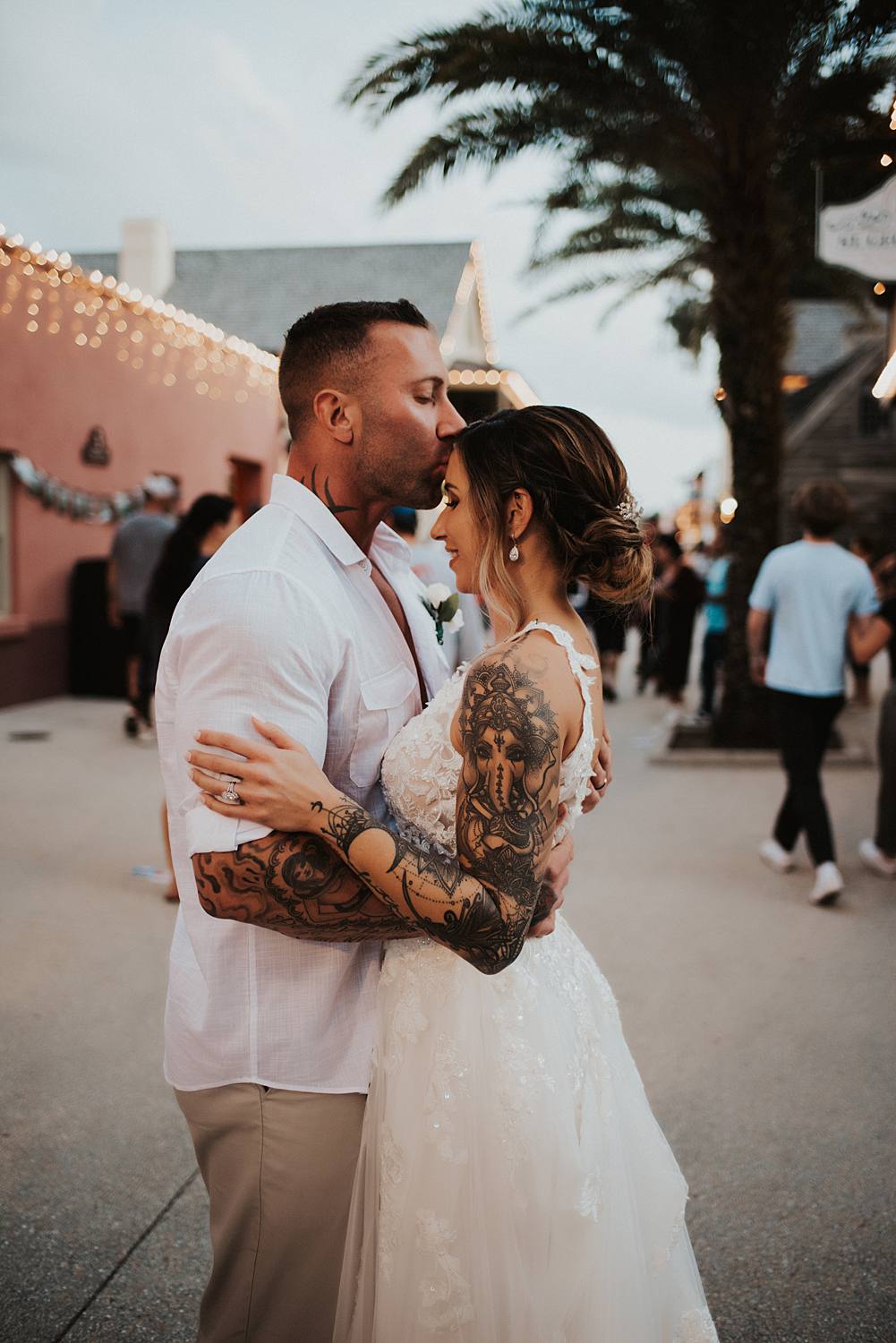 Groom kissing brides forehead on Saint George street