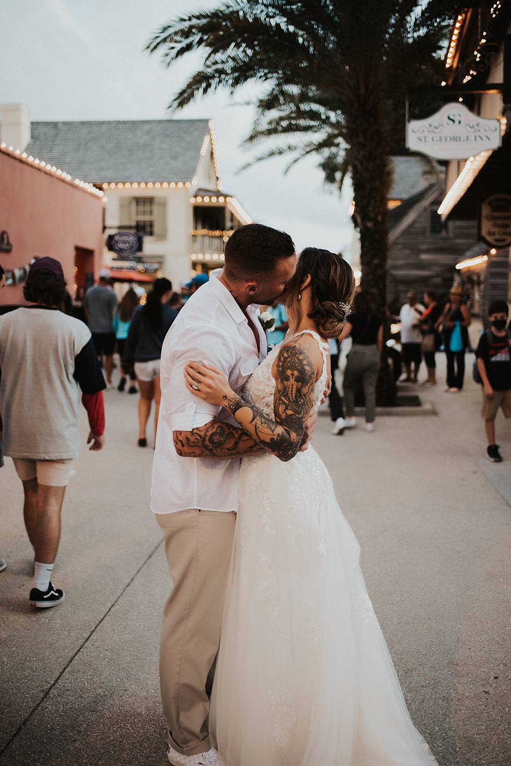 Groom kissing brides cheek on Saint George street