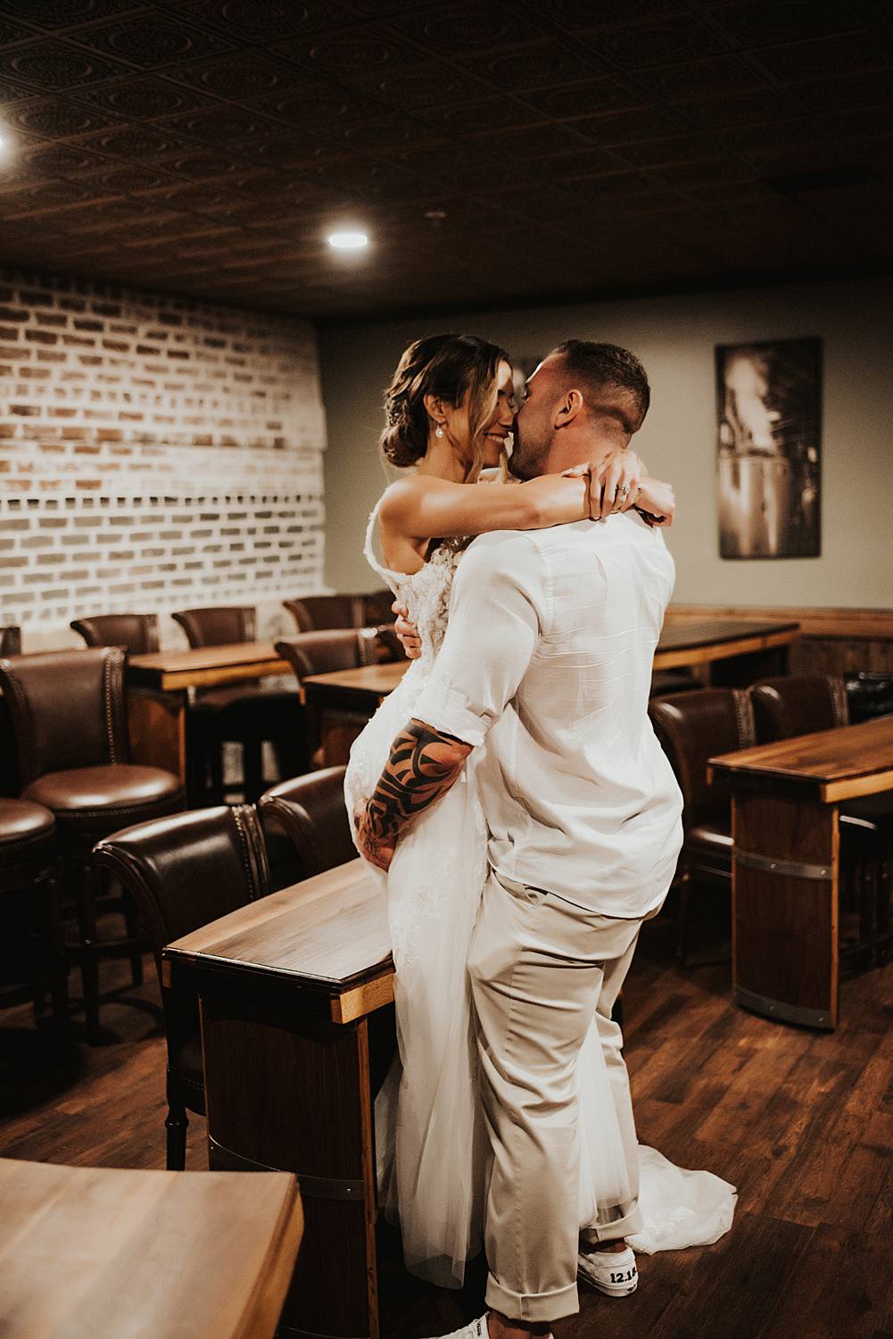 Bride and groom kissing at Saint Augustine Distillery
