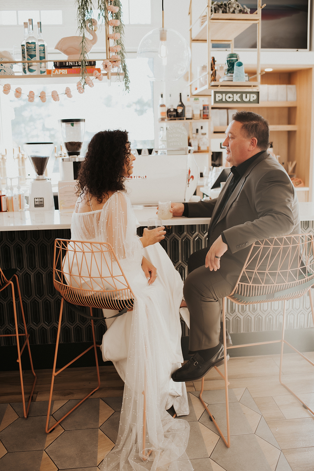 Bride and groom sitting at bar of Fonville Press in Rosemary Beach