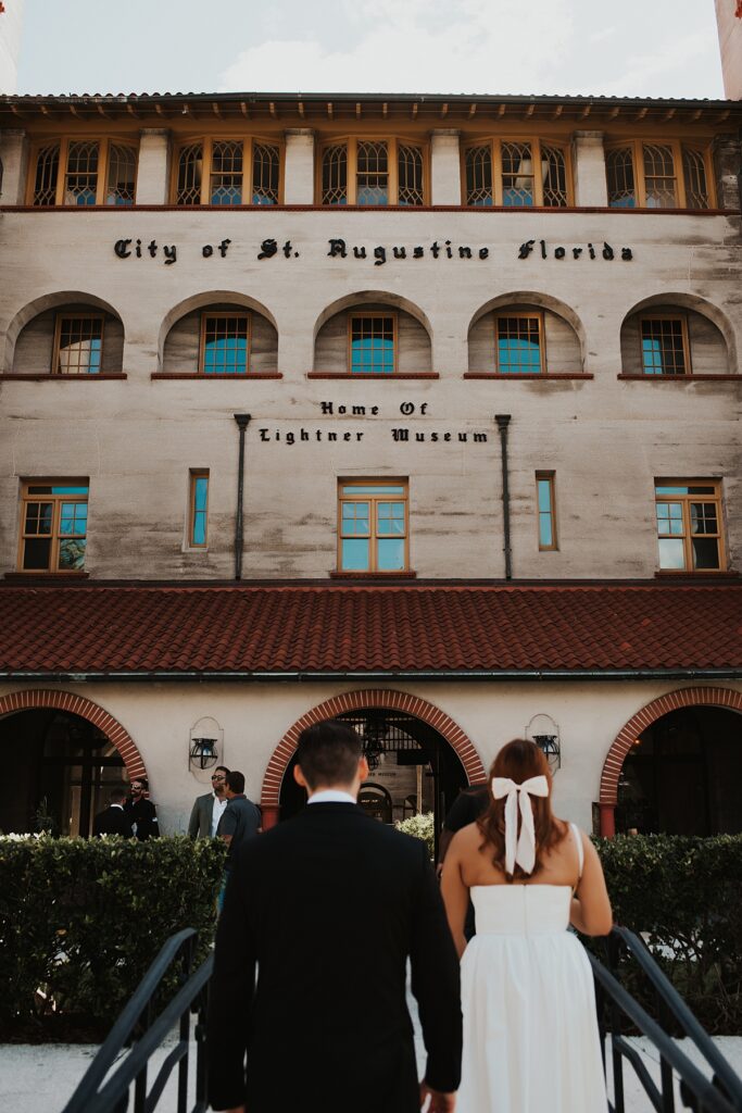 Bride and groom walking into the Ligthner Museum for their Lightner Museum Courtyard elopement