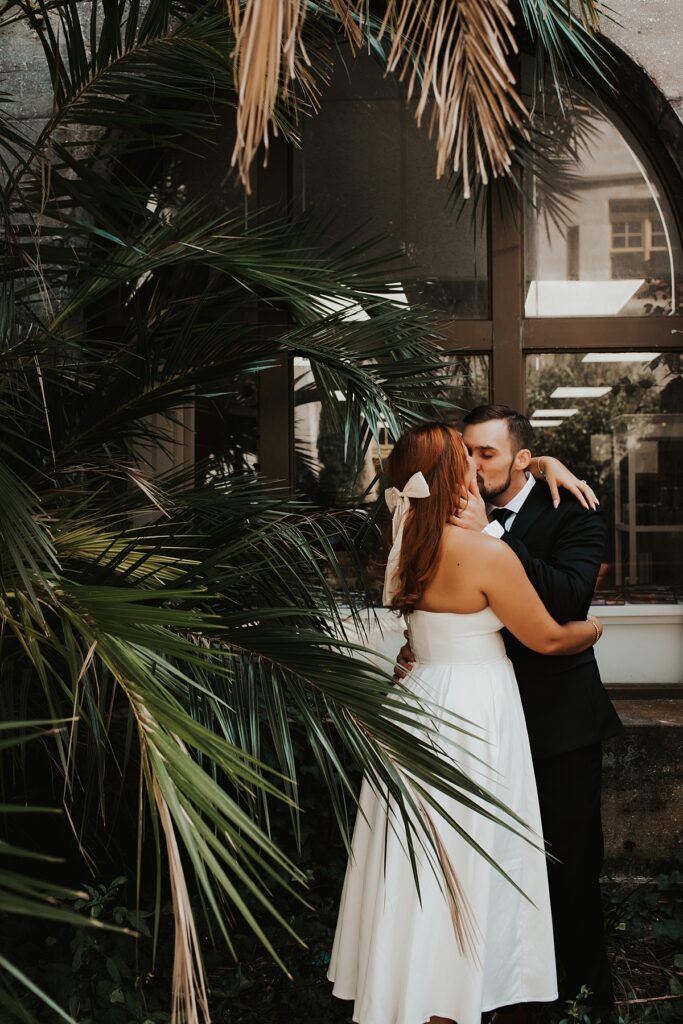 Bride and groom kissing in the gardens of the Lightner Museum after their Lightner Museum courtyard elopement