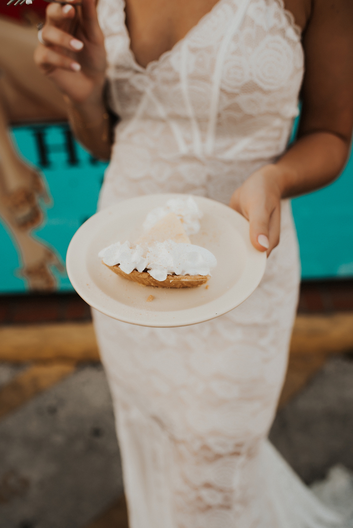 Bride holding a piece of key lime pie on a plate in Key West