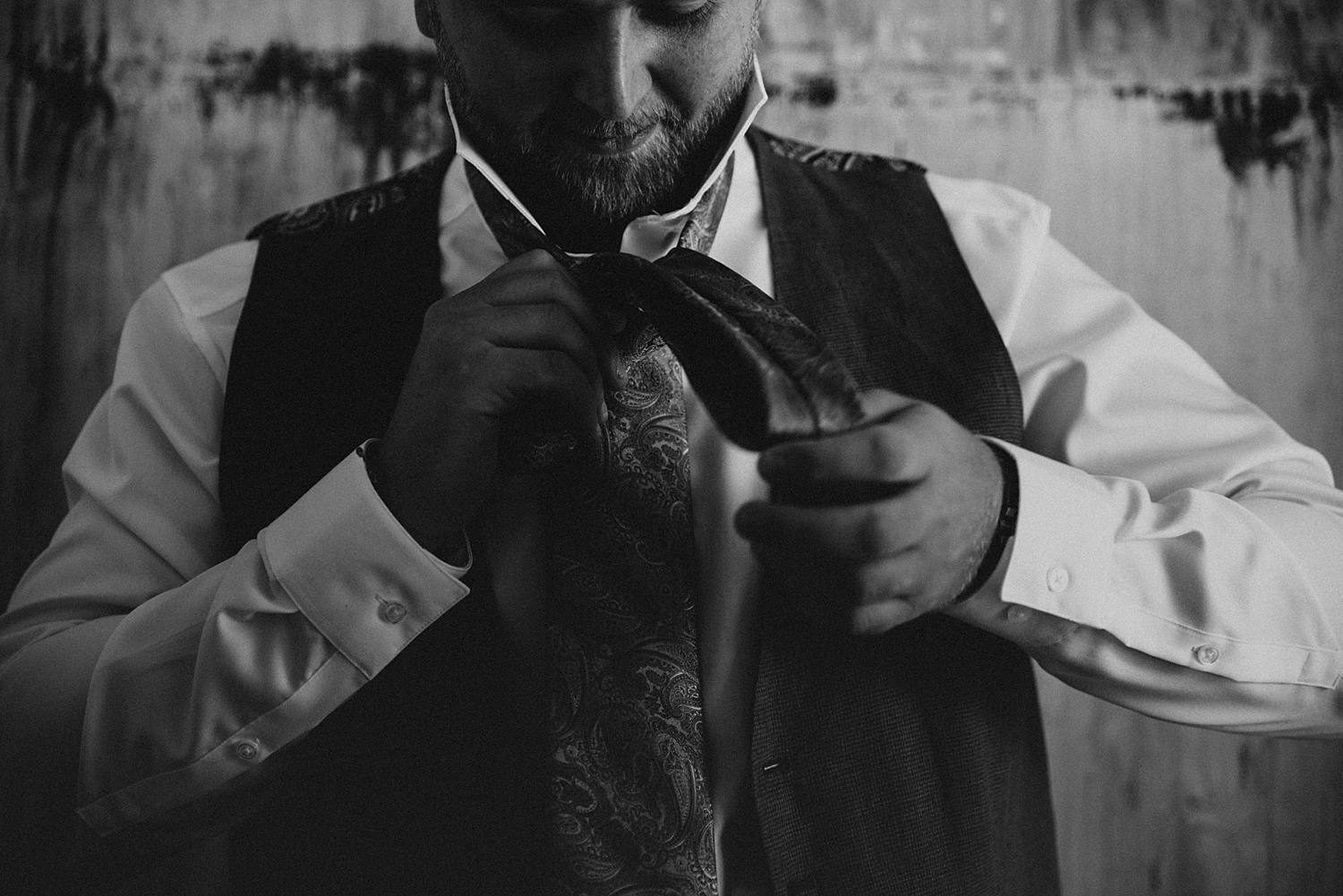Groom tying tie