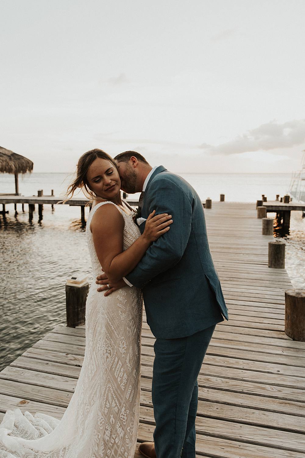 Bride and groom eloping on dock in Roatan Honduras