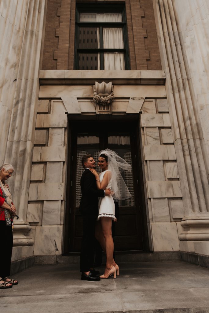Bride and grooms first kiss on le meridien tampa front steps