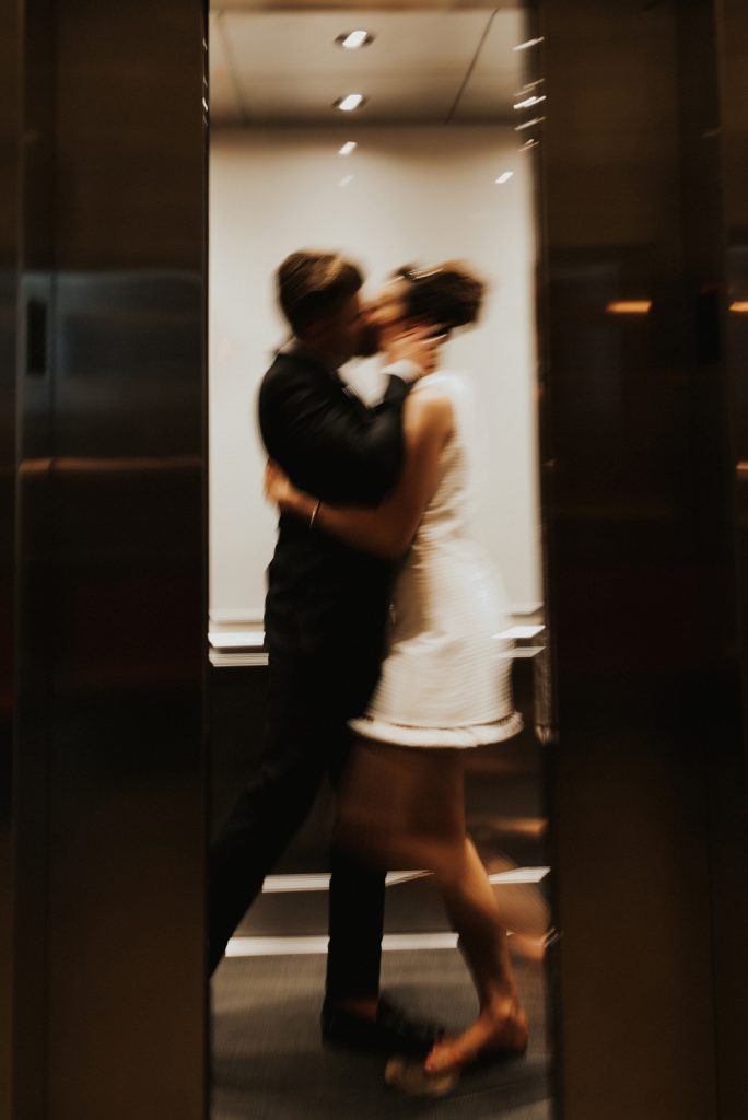 Bride and groom kissing in elevator in Le meridien tampa