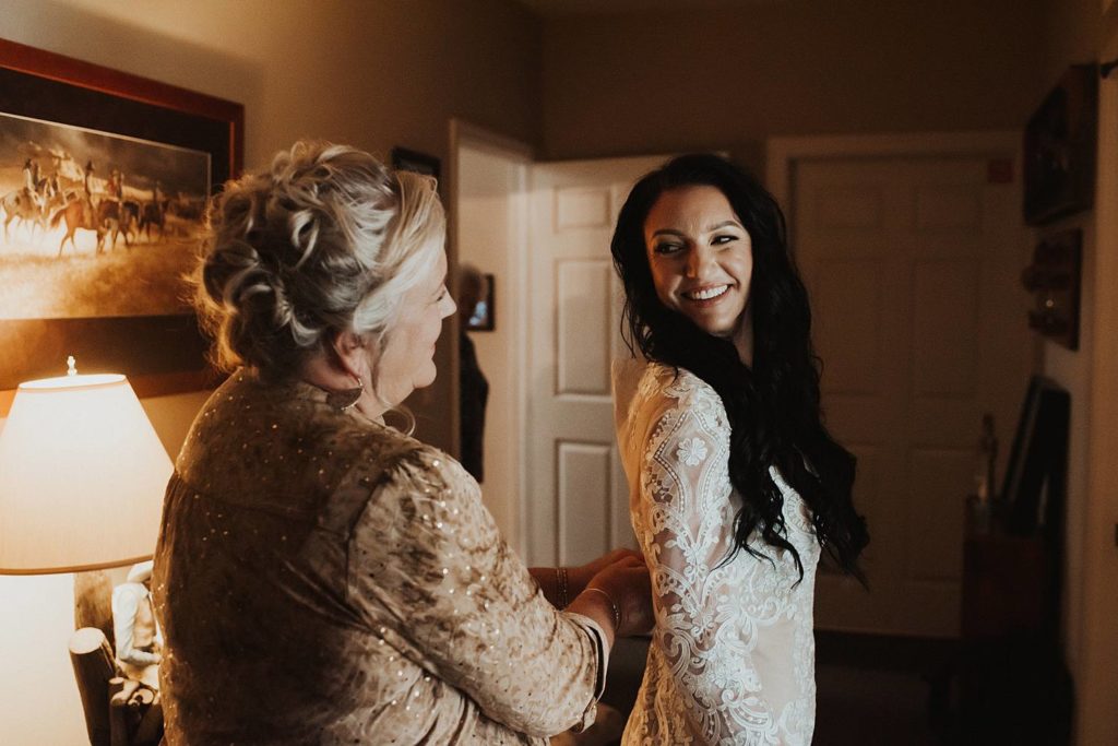 Wedding photography of bride getting ready with mother