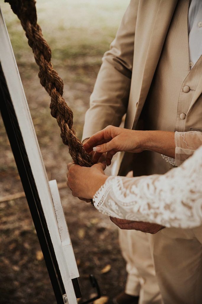 Bride and groom tying the knot during okeechobee wedding ceremony