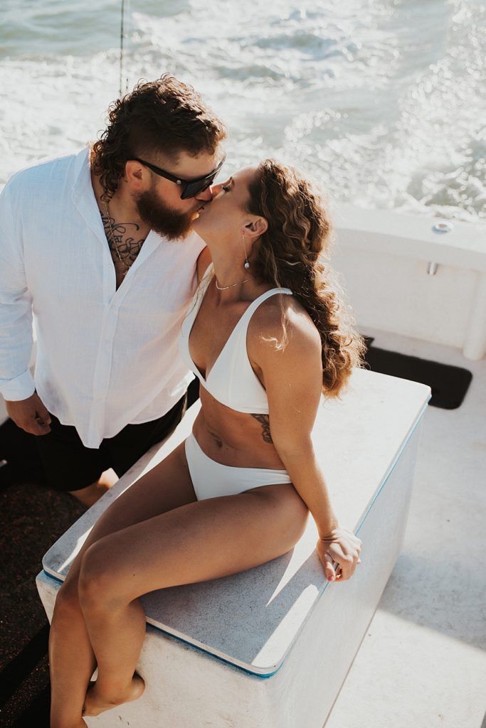 Bride and groom hanging on a boat