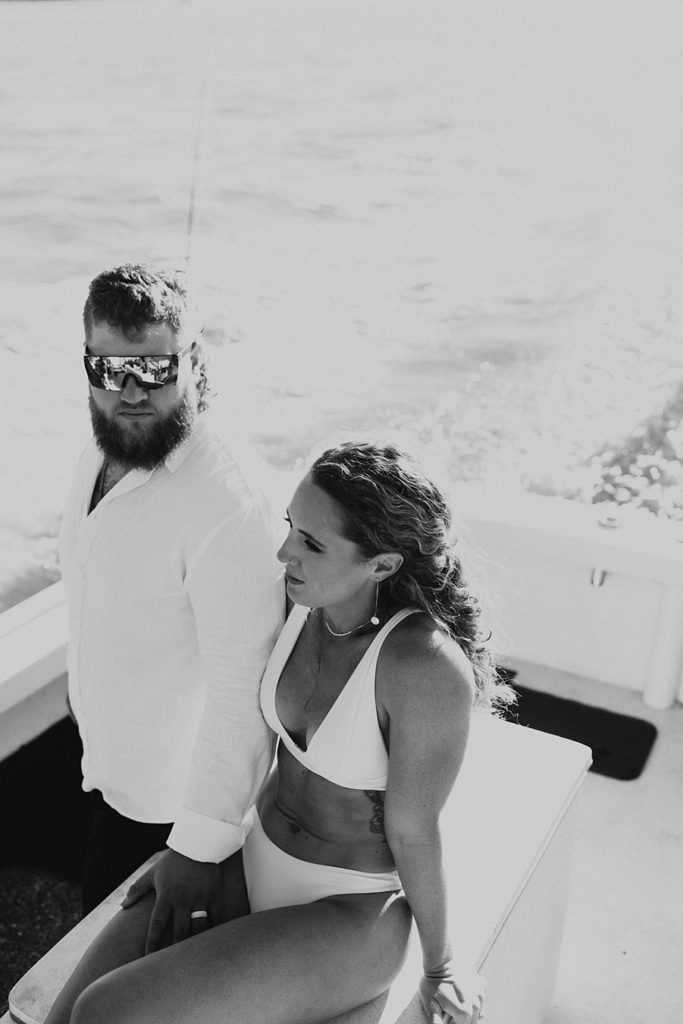 Bride and groom hanging on a boat