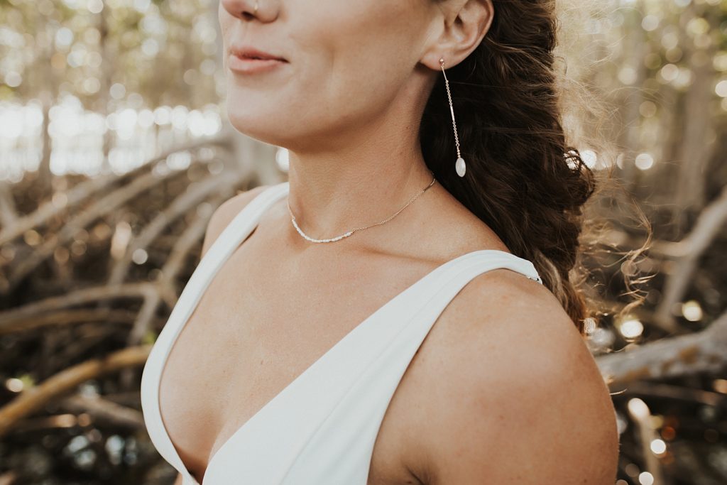 Bride with drop earrings in white bikini