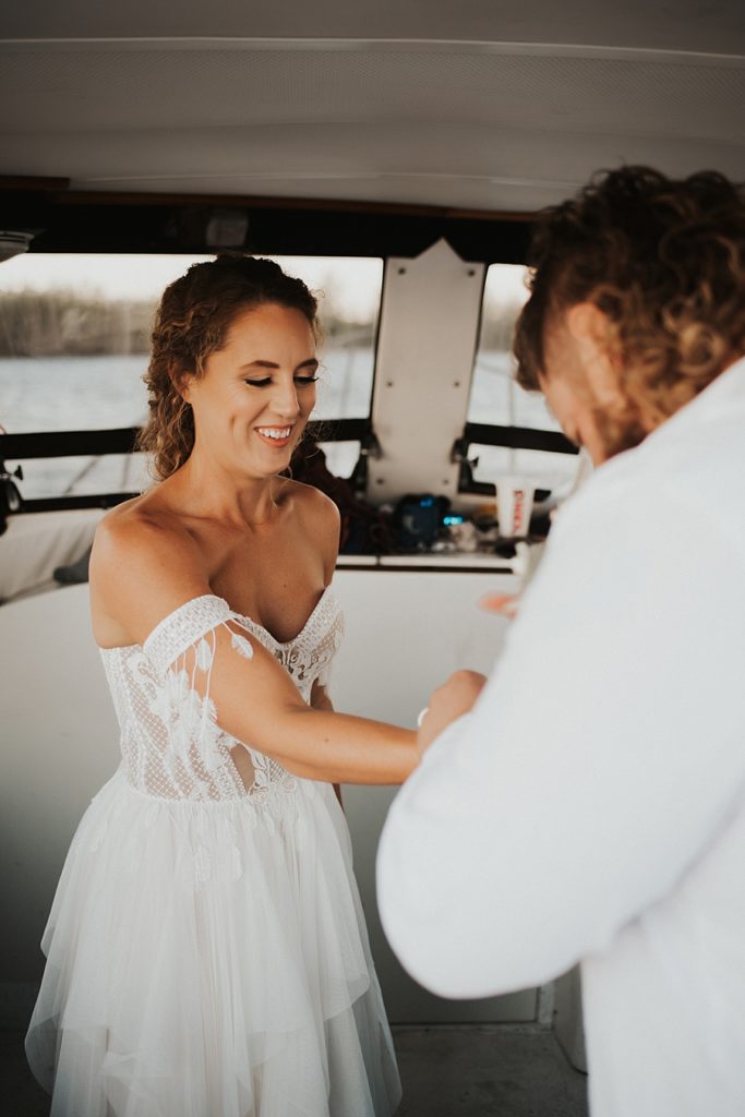 Groom helping bride get ready for elopement