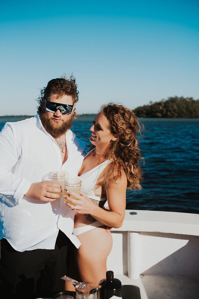 Bride and groom mixing cocktails on boat