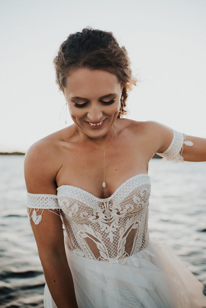 Bride smiling in white corset dress