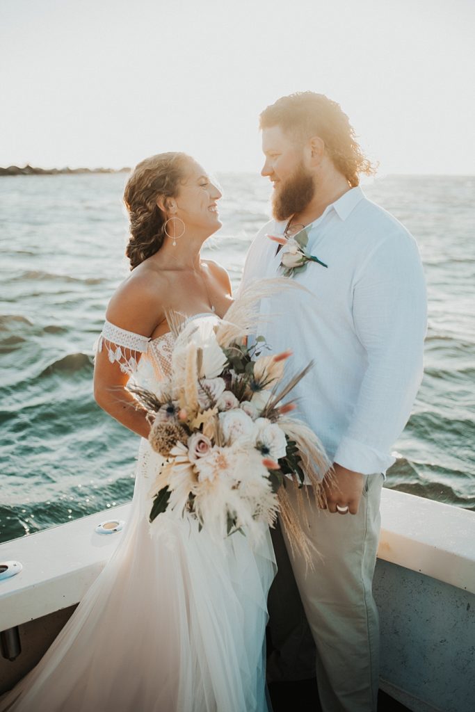 Bride and groom looking at each other on boat