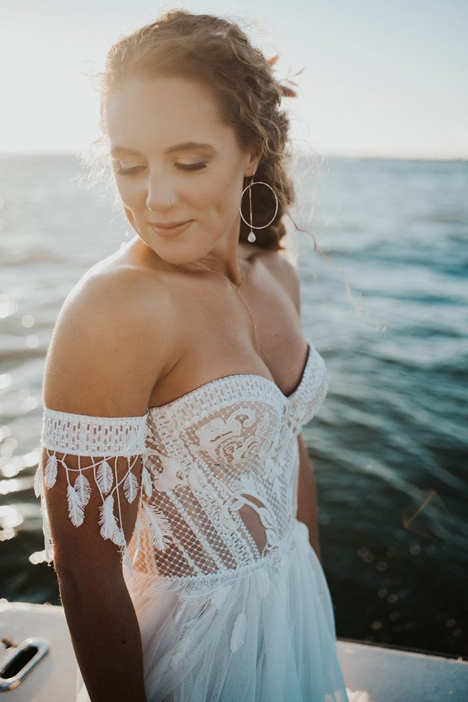 Corset dress with arm cuffs during ocean elopement