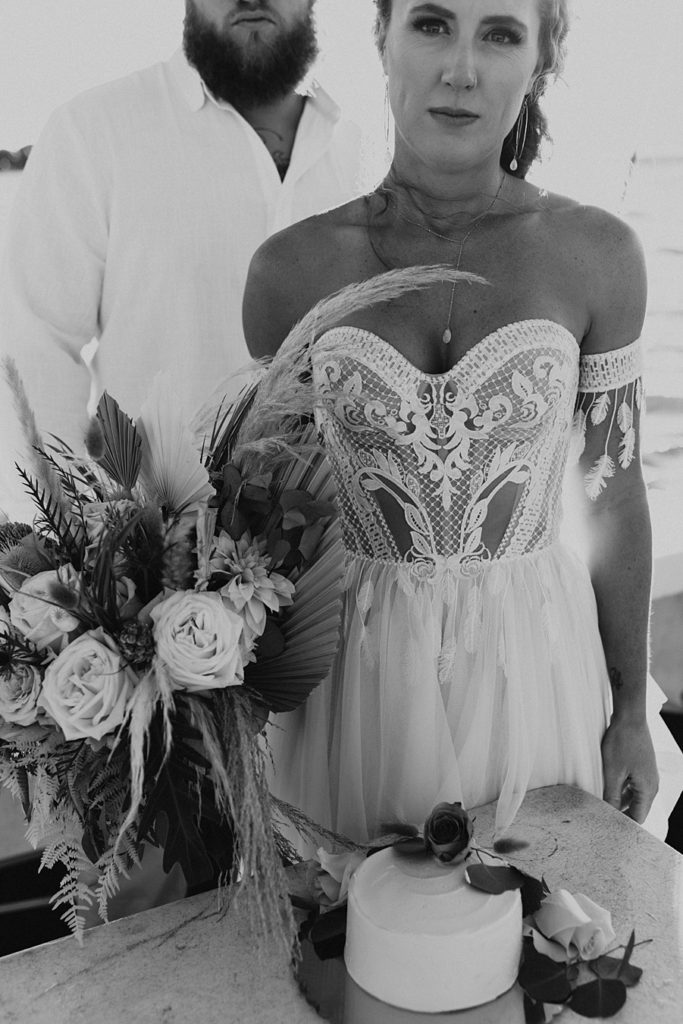 Dried floral bouquet next to corset wedding dress