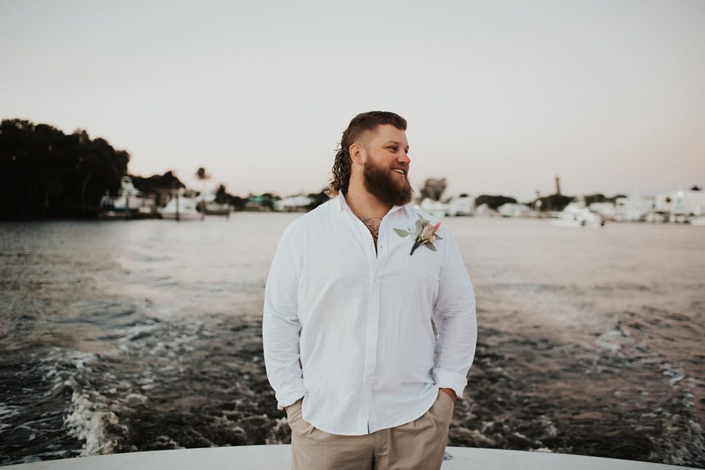 Groom in white button down on boat