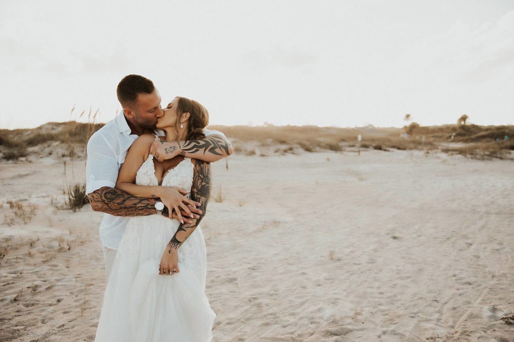 Bride and groom kissing on Saint Anastasia beach