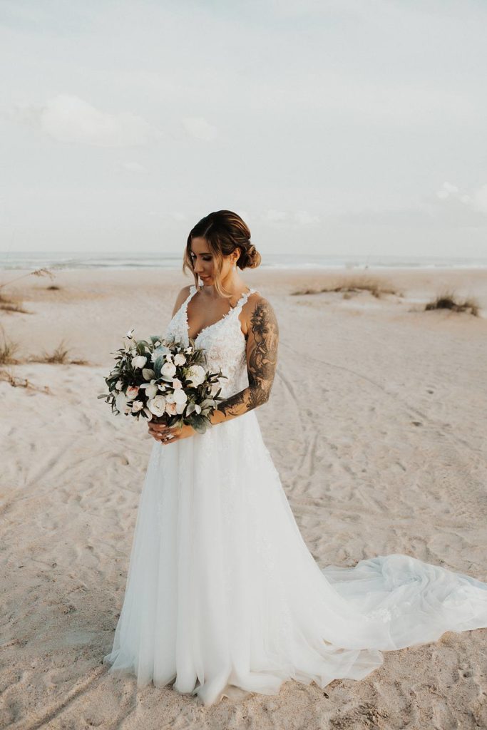 Bride holding bouquet on Saint Anastasia beach