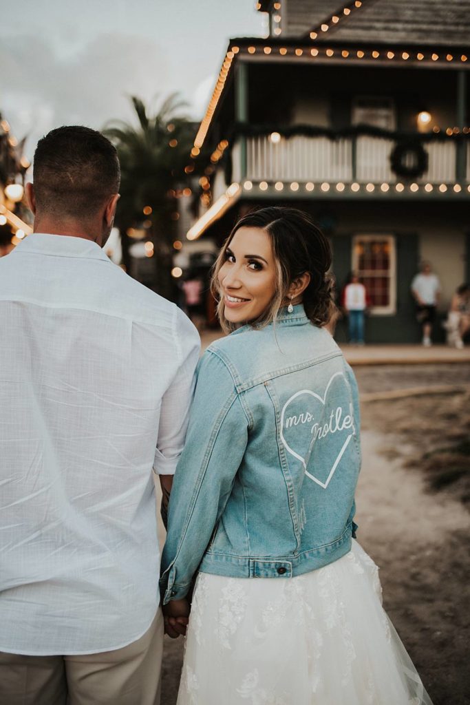 Bride smiling in custom jean jacket