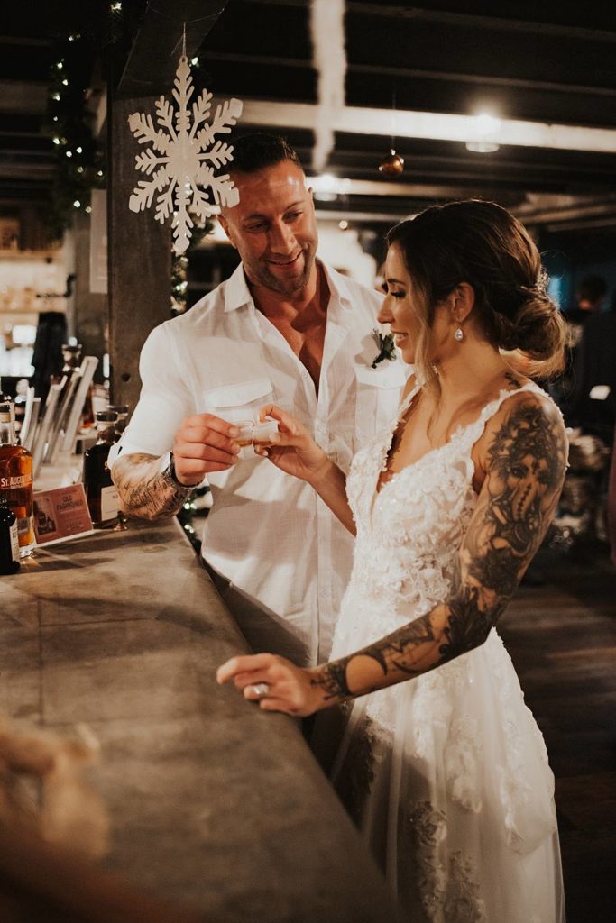 Bride and groom taking a shot at Saint Augustine Distillery