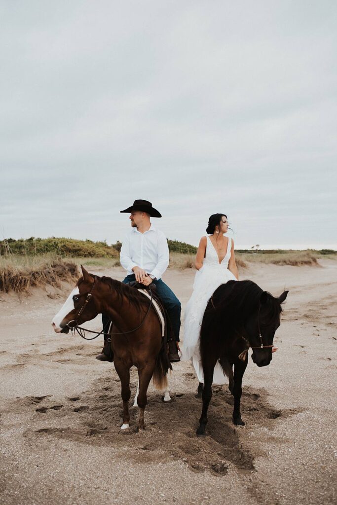 Bride and groom riding horses at the beach in Florida for their elopement
