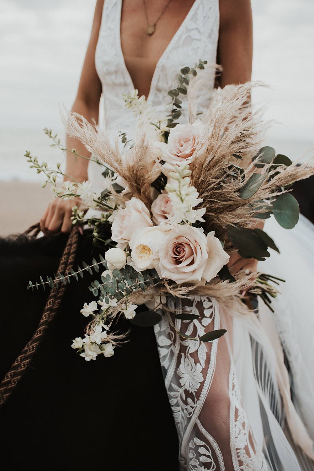 Neutral elopement bouquet with bride sitting on a horse