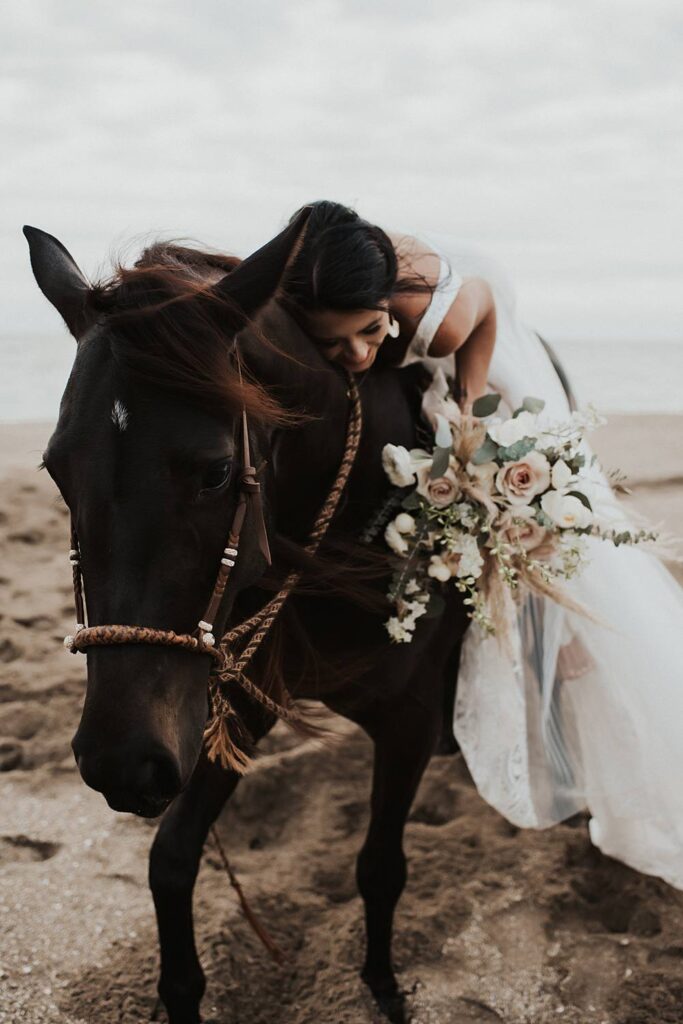 Neutral elopement bouquet with bride sitting on a horse