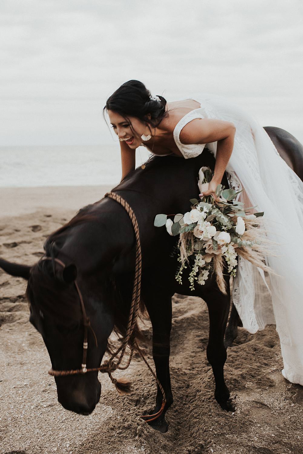 Neutral elopement bouquet with bride sitting on a horse