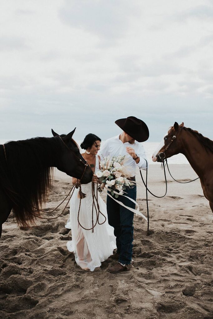 Bride and groom first kiss on Florida beach during their elopement with their horses