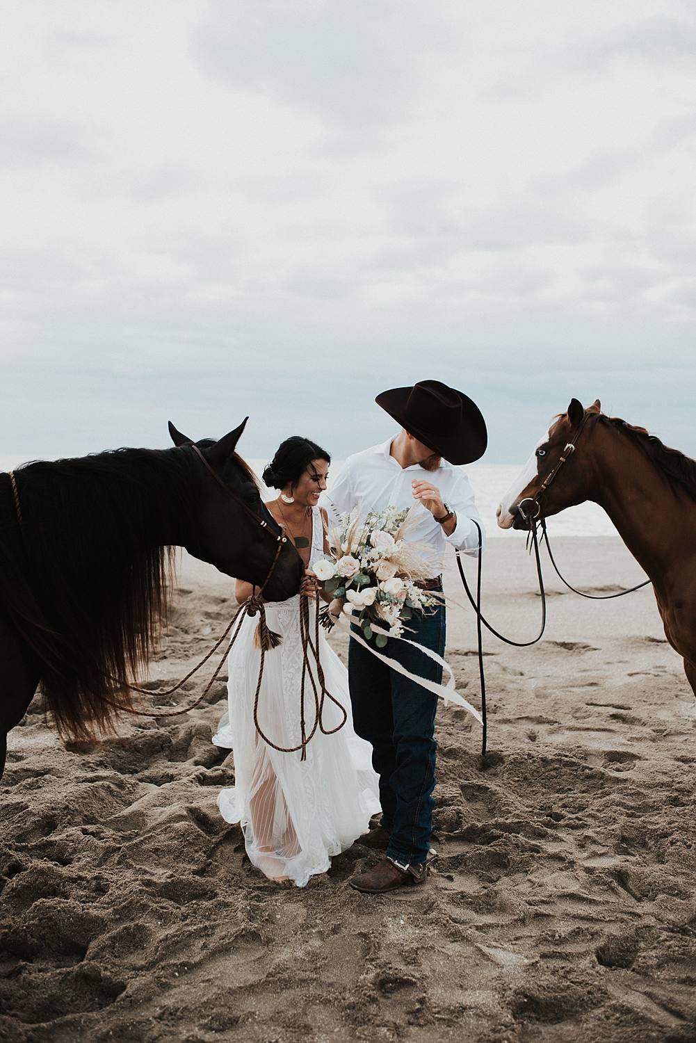 Bride and groom first kiss on Florida beach during their elopement with their horses