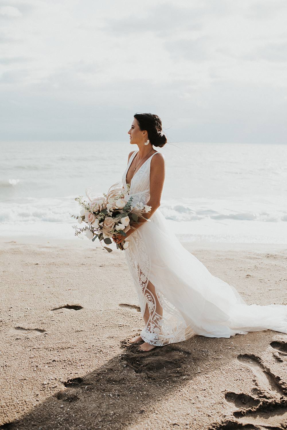 Bridal portrait on the beach at sunrise with neutral floral bouquet