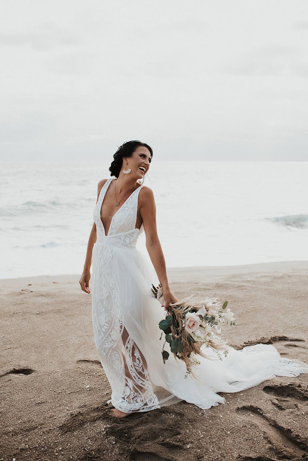 Bridal portrait on the beach at sunrise with neutral floral bouquet