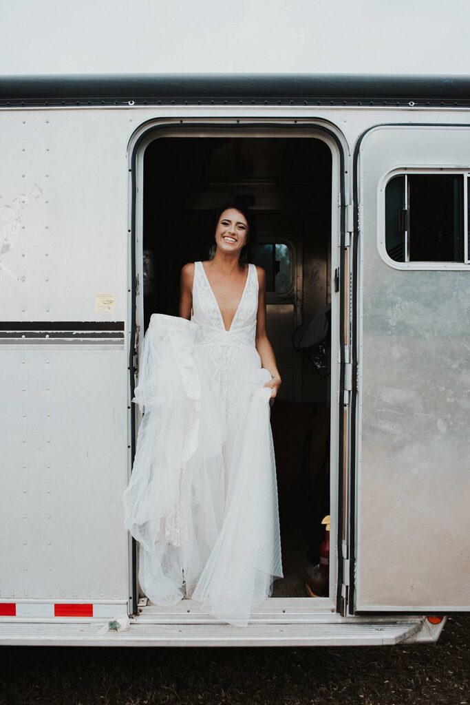 Bride getting ready in her horse trailer at the beach for her Florida elopement