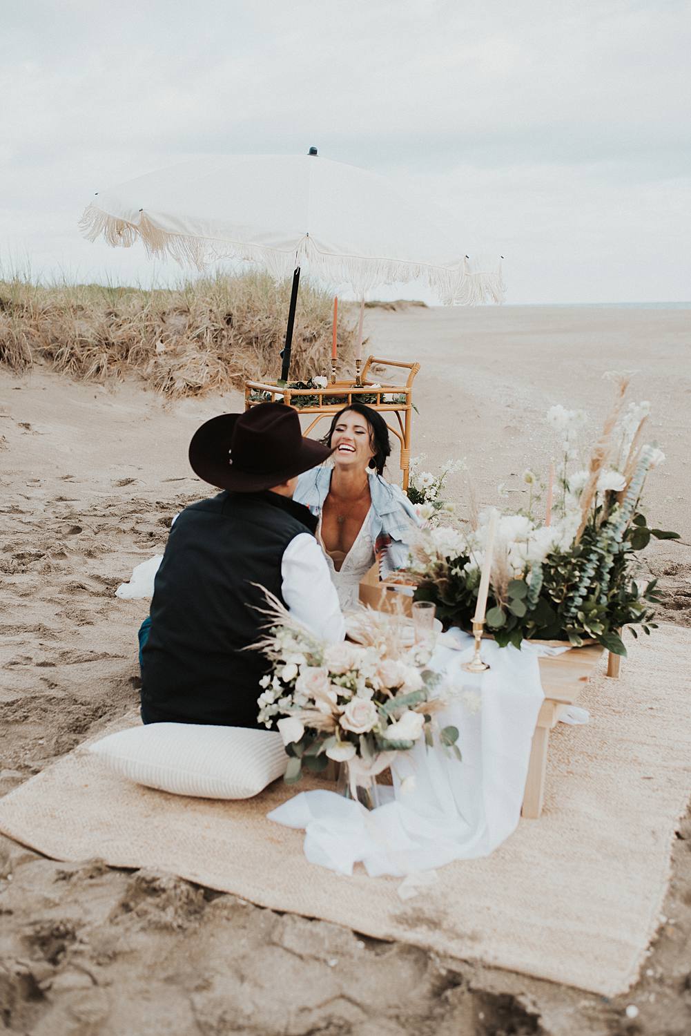 Bride and groom enjoying their luxury picnic on the beach after their Florida elopement