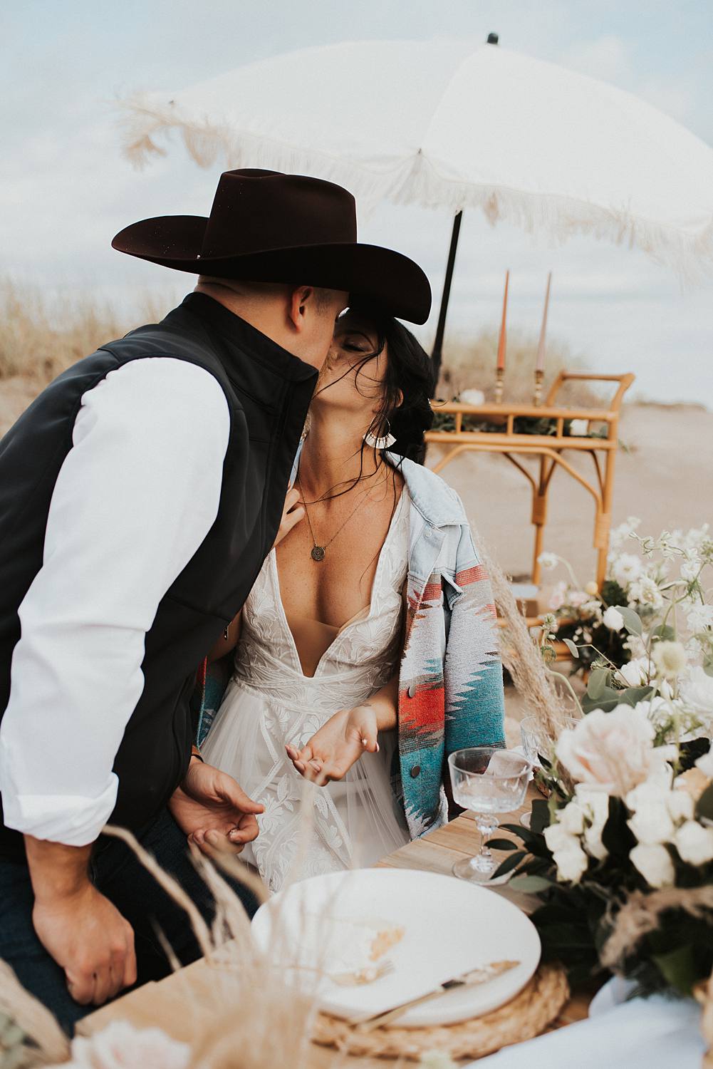 Bride and groom cutting their cake from their luxury picnic on the beach after their Florida elopement