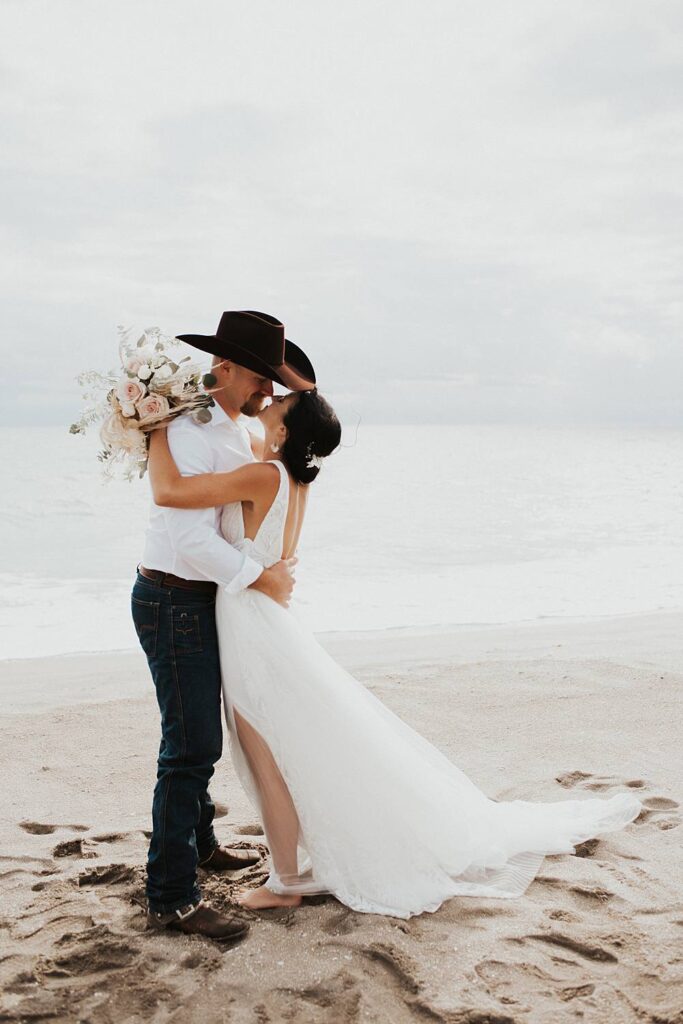 Bride and groom kissing on the beach after their Florida elopement