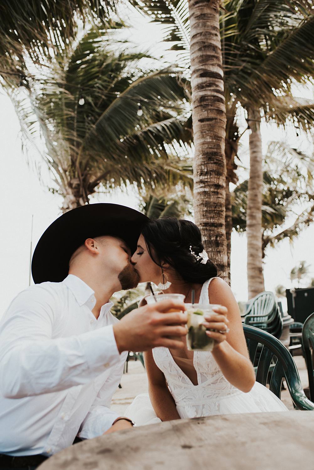 Bride and groom at beach bar for post celebratory drinks after their Florida beach elopement