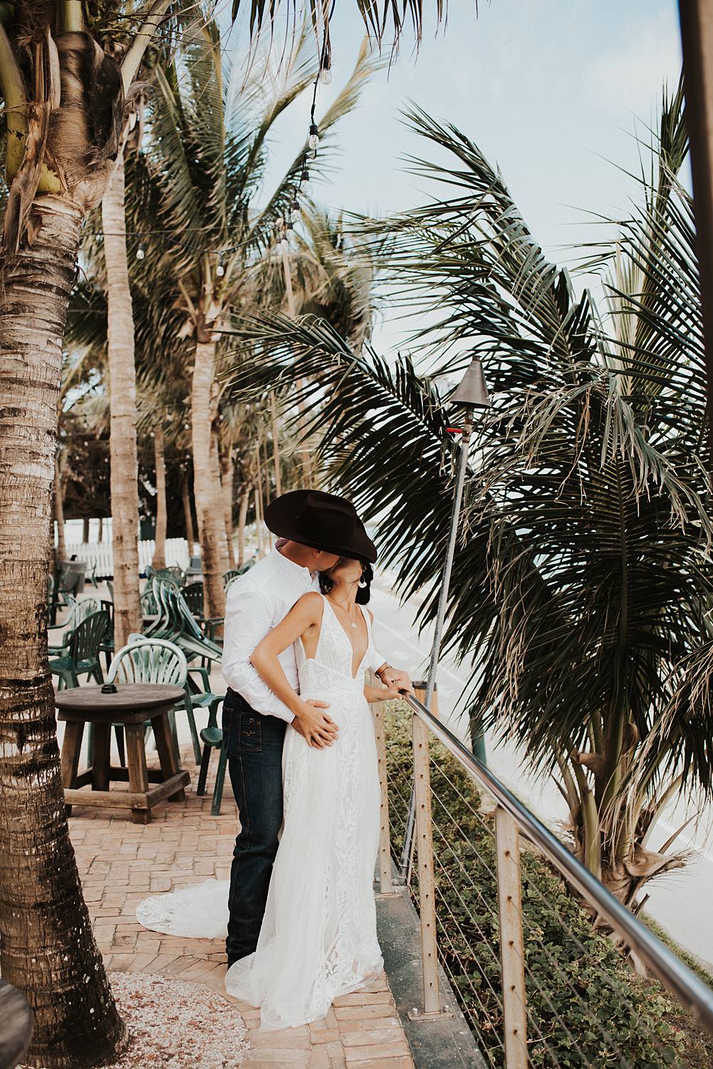 Bride and groom at beach bar for post celebratory drinks after their Florida beach elopement