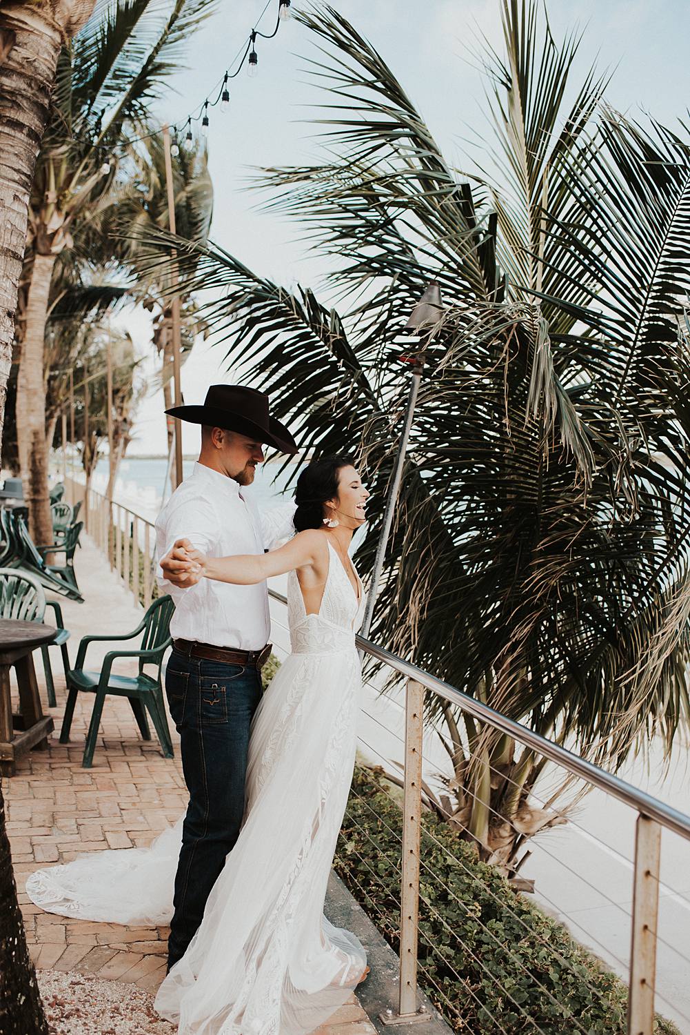 Bride and groom at beach bar for post celebratory drinks after their Florida beach elopement