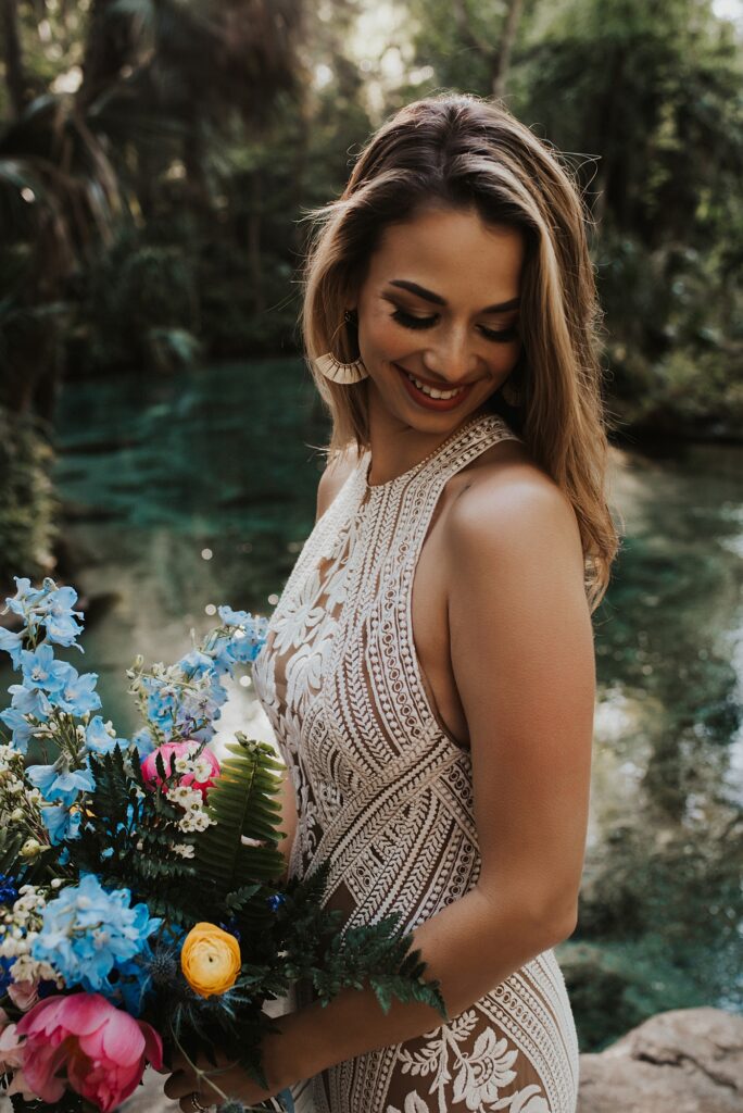 Bride with spring floral bouquet at Kelly Park Rock Springs in Apopka Florida during her elopement