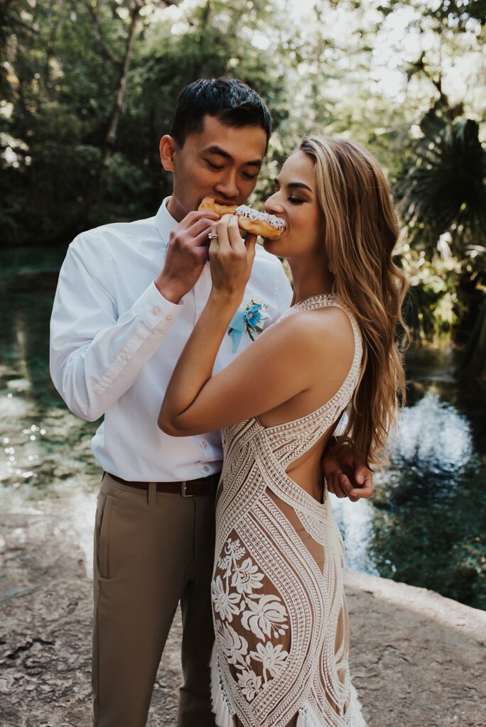 Bride and groom eating donuts at Kelly Park Rock Springs in Apopka Florida during her elopement