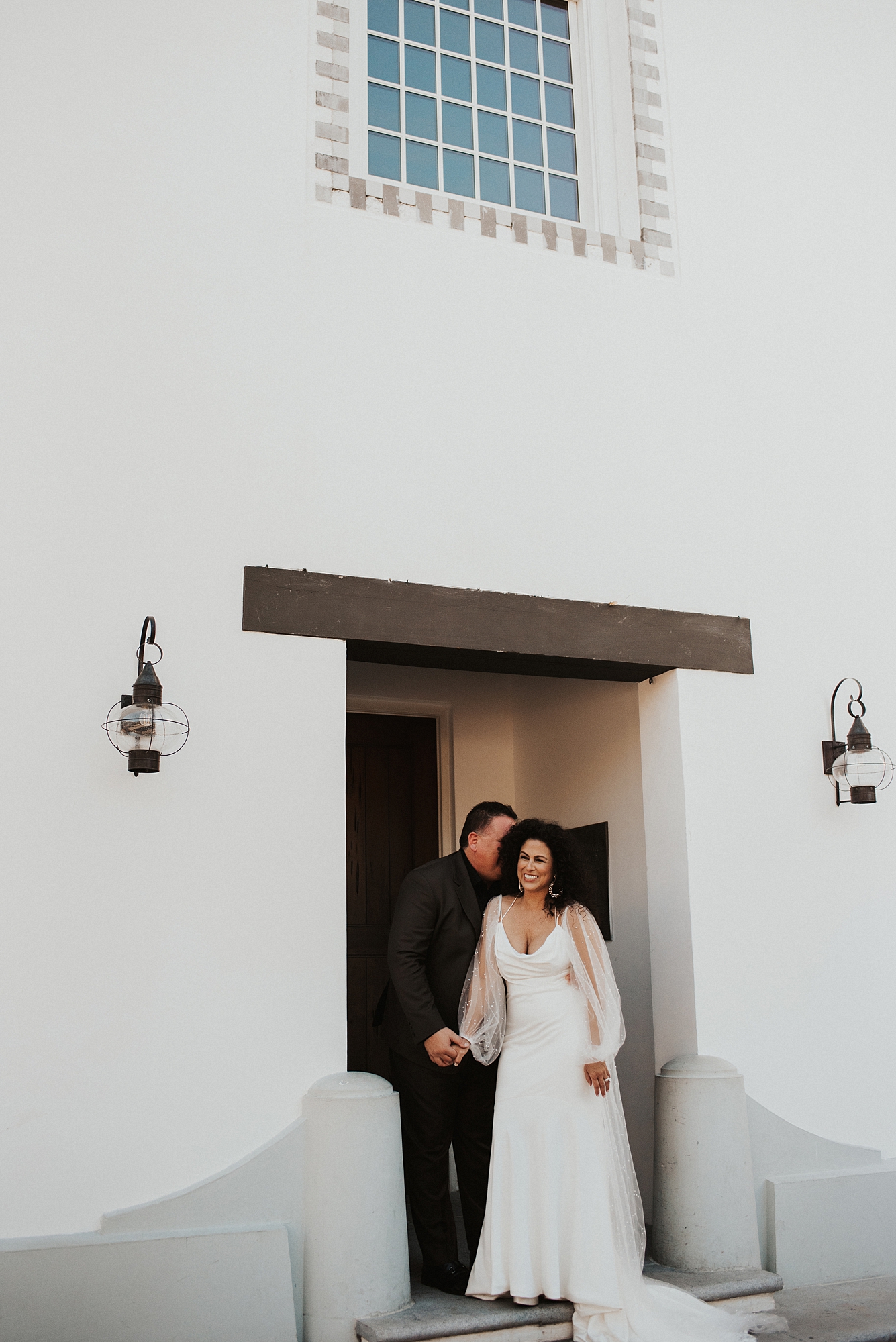 Bride and groom in front of Rosemary Beach town hall